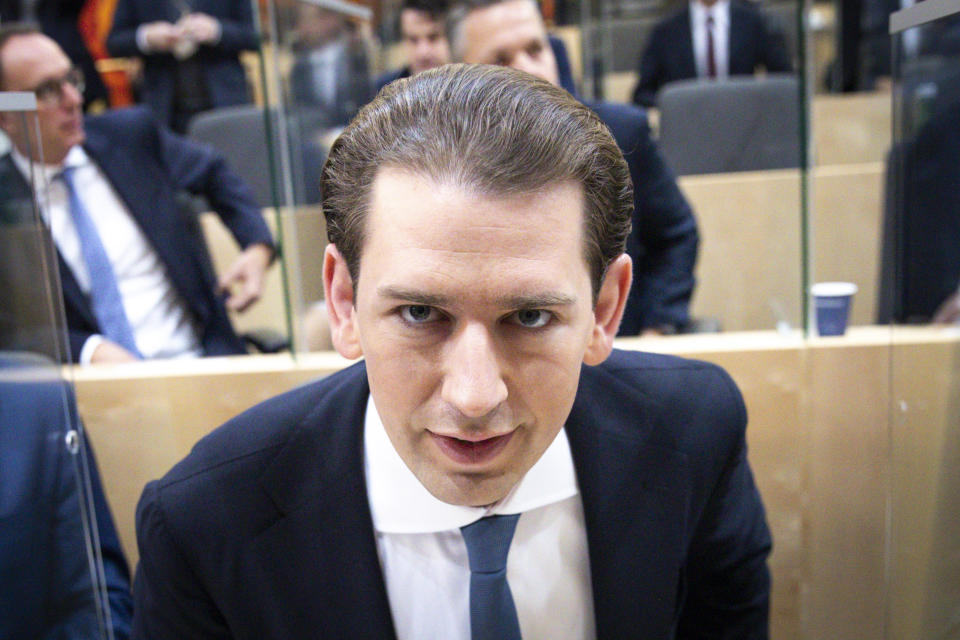 Sebastian Kurz, the former Austrian Chancellor, takes his seat before the sworn-in as deputy in the Austrian Parliament in Vienna, Austria, Thursday, Oct. 14, 2021. (AP Photo/Lisa Leutner)