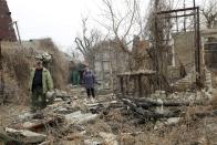 Local citizens visit their home in the separatist-controlled territory to collect belongings after a recent shelling near a frontline outside Donetsk, eastern Ukraine, Friday, April 9, 2021 .Tensions have built up in recent weeks in the area of the separatist conflict in eastern Ukraine, with violations of a cease-fire becoming increasingly frequent. (AP Photo)