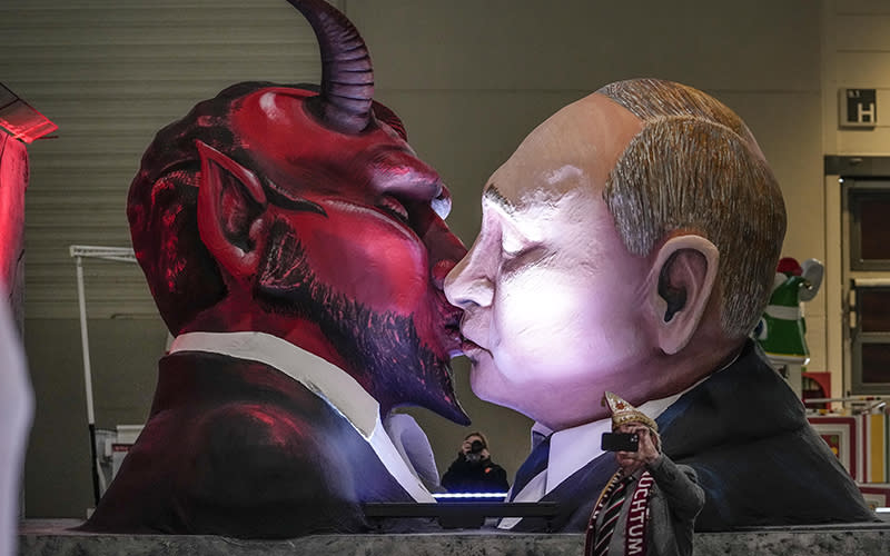 A carnival float depicts Russia's President Vladimir Putin kissing the devil