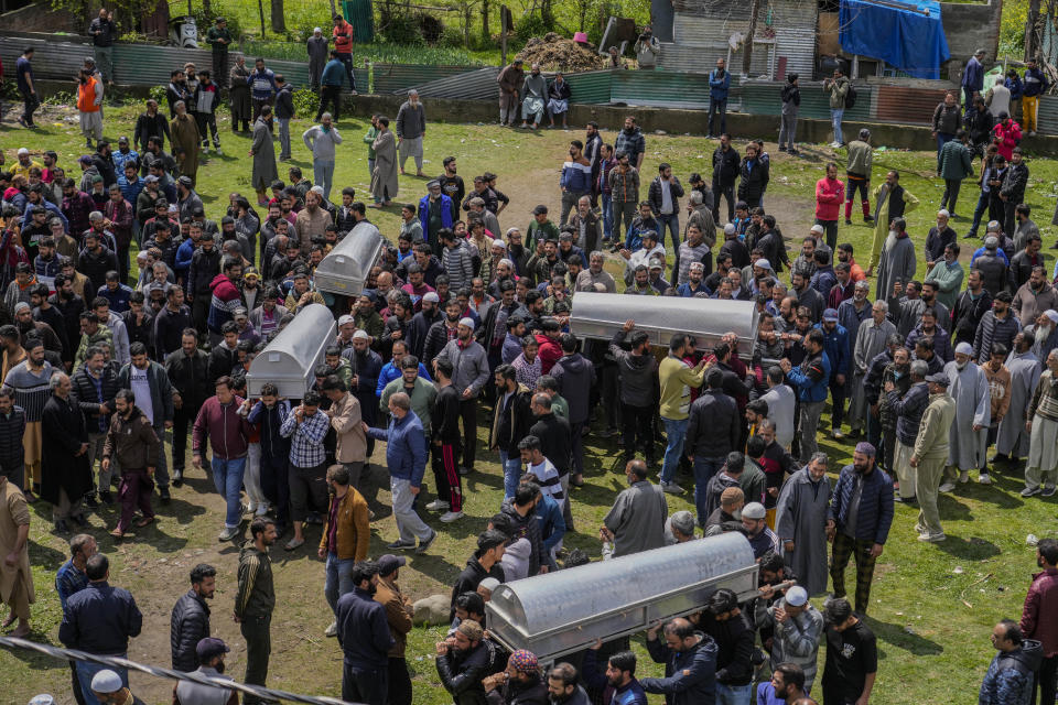 People carry coffins during a joint funeral of victims of a boat capsize on the outskirts of Srinagar, Indian controlled Kashmir, Tuesday, April. 16, 2024. The boat capsized in Jhelum river, most of the passengers were children, and rescuers were searching for many others who were still missing. (AP Photo/Mukhtar Khan)