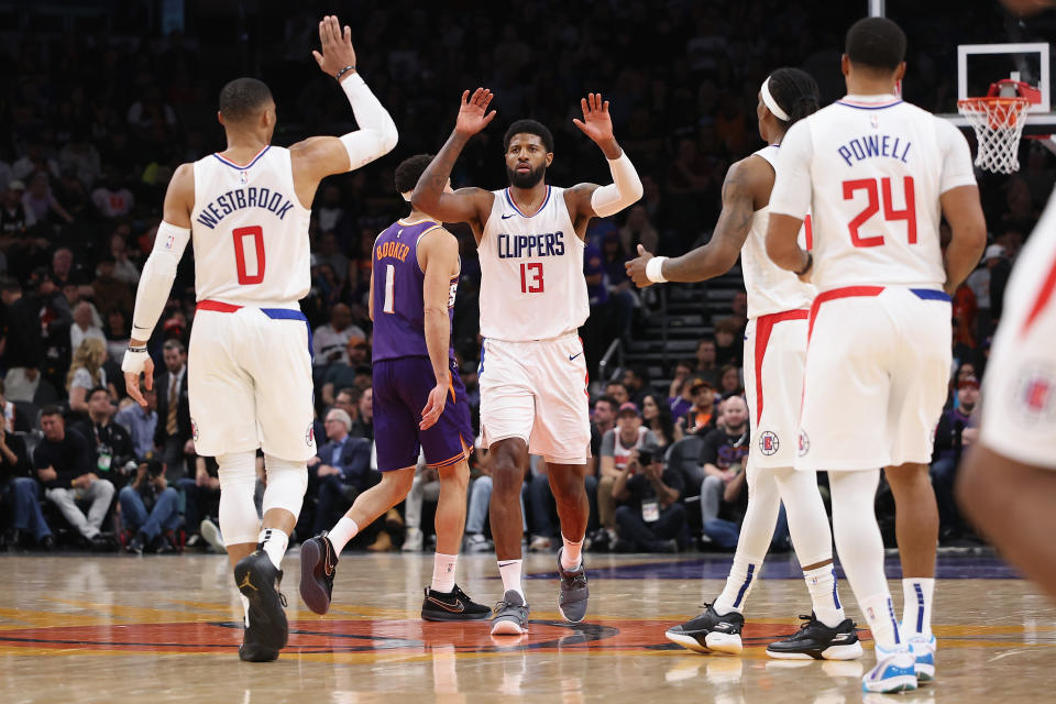 PHOENIX, ARIZONA - APRIL 09: Paul George #13 of the LA Clippers high fives Russell Westbrook #0, Terance Mann #14 and Norman Powell #24 during the second half of the NBA game at Footprint Center on April 09, 2024 in Phoenix, Arizona. NOTE TO USER: User expressly acknowledges and agrees that, by downloading and or using this photograph, User is consenting to the terms and conditions of the Getty Images License Agreement. (Photo by Christian Petersen/Getty Images)