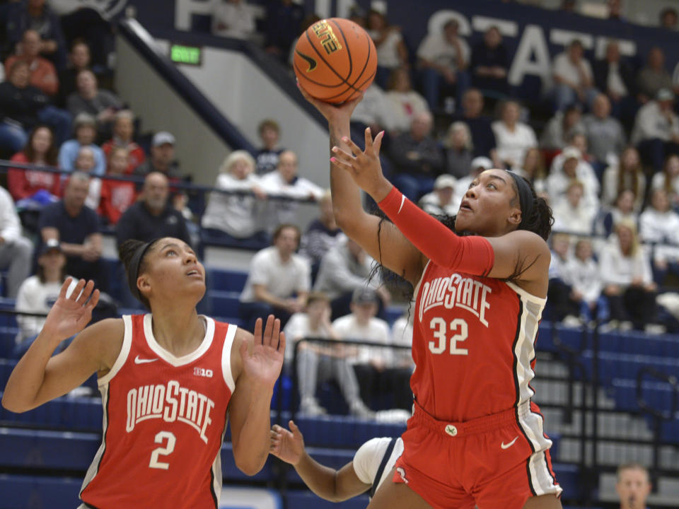 Ohio State's Taylor Thierry (2) watchers as teammate Cotie McMahon (32) scores on a layup against Penn State during the first half of an NCAA college basketball game Thursday, Feb. 22, 2024, in State College, Pa. (AP Photo/Gary M. Baranec)