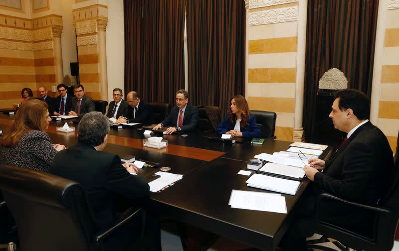 Lebanese Prime Minister Hassan Diab and officials meet with a team of IMF experts at the government palace in Beirut