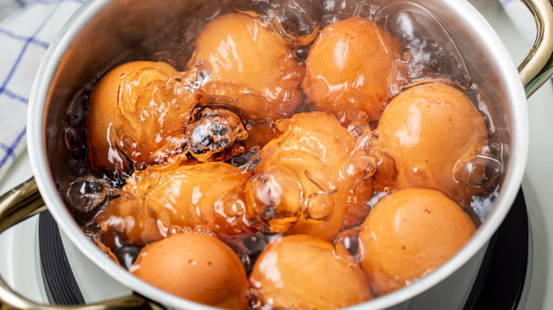 Boiling brown eggs in a pot