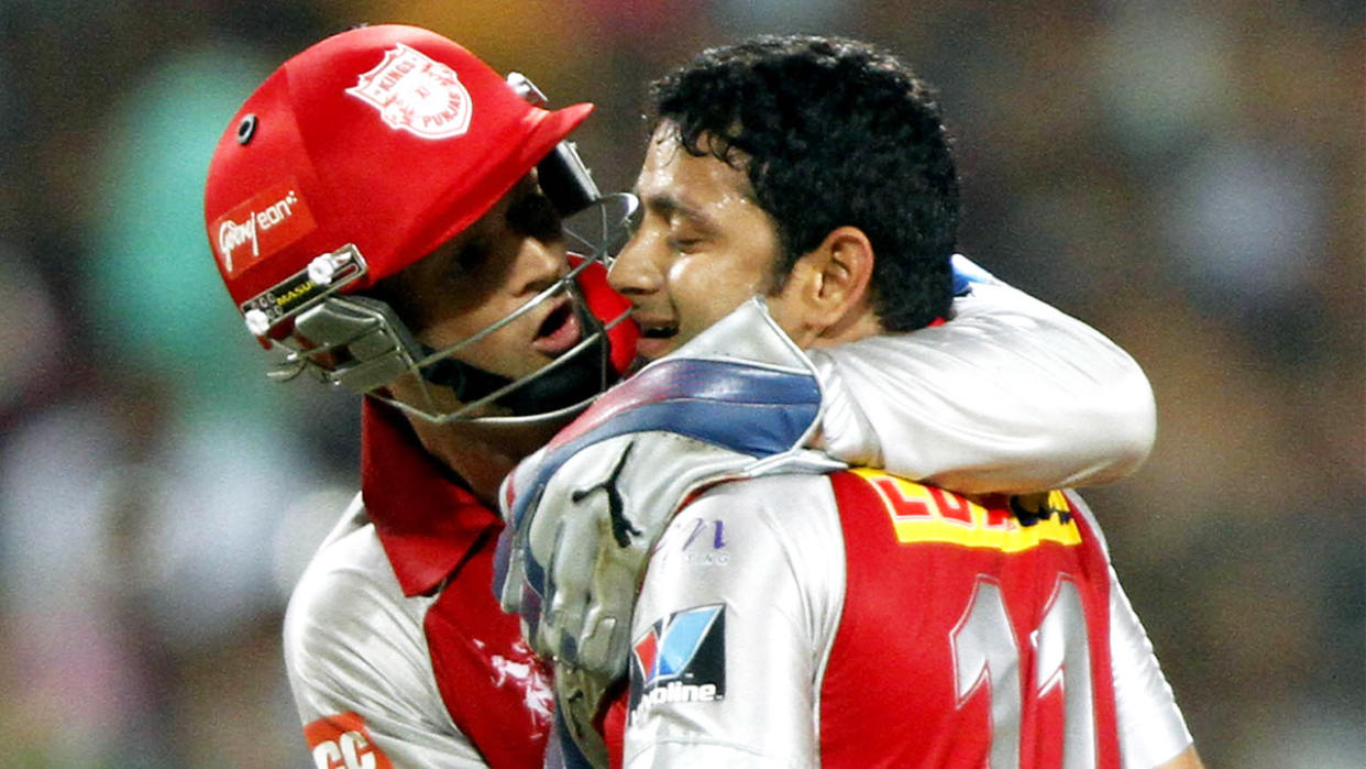 Adam Gilchrist (pictured left) hugs Piyush Chawla (pictured right) after a wicket in the IPL.