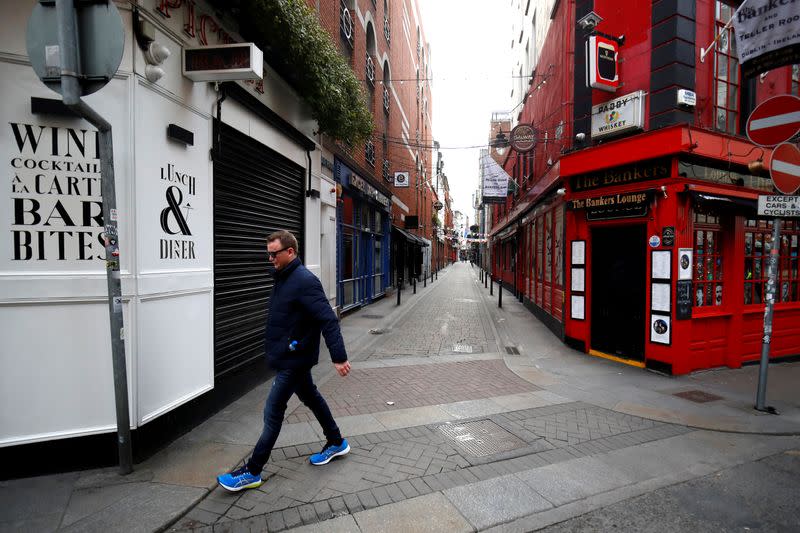 A man walks past a pub in Dublin on St. Patrick's Day as public events were cancelled as the number of coronavirus cases grow around the world