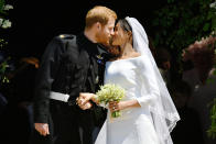<p>Prince Harry and Meghan Markle kiss on the steps of St George’s Chapel after their wedding ceremony. (Photo: Ben Birchall – WPA Pool/Getty Images) </p>