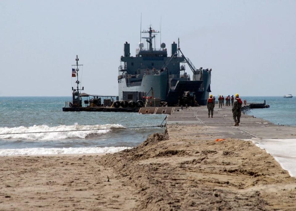 Logistic Support Vessel General Frank S. Besson near a sandy coast