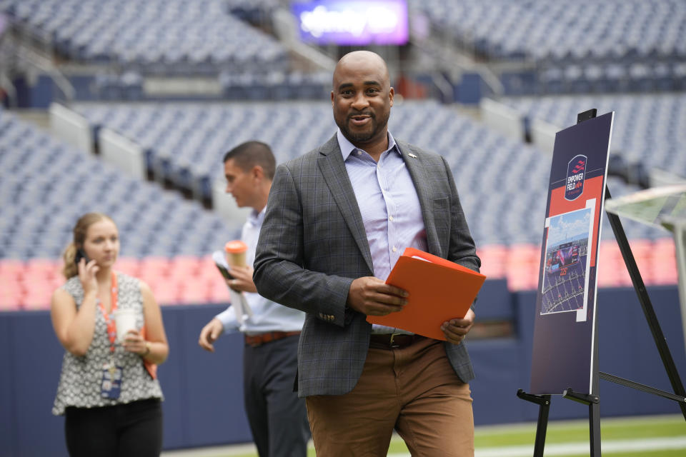 Damani Leech, president of the Denver Broncos, greets reporters during a media tour to show the $100-million upgrades made to Empower Field at Mile High, the home to the NFL football team, Friday, Aug. 25, 2023, in Denver. The upgrades include a new scoreboard, which is the fifth-largest in the league, as well as premium hospitality areas, renovated suites and team store plus artwork scattered throughout the stadium featuring the Broncos' history. (AP Photo/David Zalubowski)