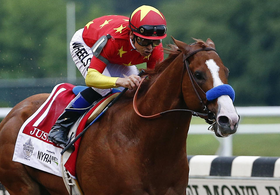 FILE - In this June 9, 2018, file photo, Justify (1), with jockey Mike Smith up, crosses the finish line to win the 150th running of the Belmont Stakes horse race and the Triple Crown in Elmont, N.Y. The undefeated Triple Crown winner has been retired from racing because of fluid in his left front ankle, trainer Bob Baffert and Justify’s owners announced Wednesday, July 25, 2018. They cited caution over the horse’s ankle making it impossible to tell if he’d be able to race by the fall. (AP Photo/Peter Morgan, File