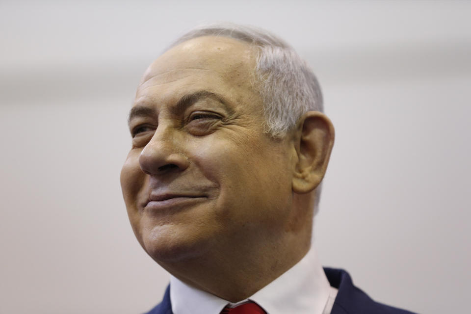 FILE - In this April 9, 2019 file photo, Israel's Prime Minister Benjamin Netanyahu smiles after voting during Israel's parliamentary elections in Jerusalem. Netanyahu has been a vocal critic of Iran over the years, accusing the Islamic Republic of sinister intentions at every opportunity. But the outspoken Israel leader has remained uncharacteristically quiet throughout the current crisis between the U.S. and Iran. (AP Photo/Ariel Schalit, Pool, File)