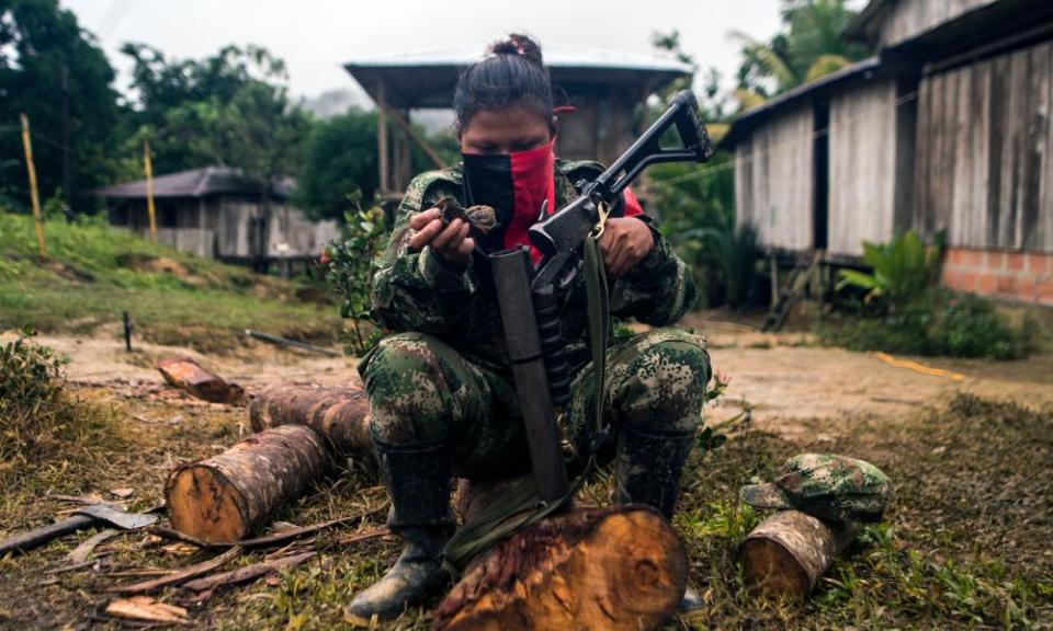 TOPSHOT-COLOMBIA-CEASEFIRE-ELNTOPSHOT - An ELN guerrilla cleans her gun in a camp on the banks of the San Juan river.