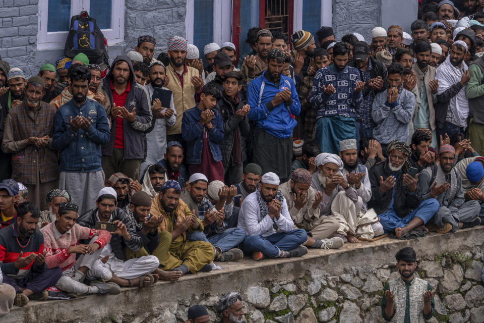 Kashmiri nomadic devotees belonging to Gujjar tribe gather for special prayers outside the forest shrine of Miyan Peer, in Baba Nagri, northeast of Srinagar, Indian controlled Kashmir, Saturday, June 8, 2024. (AP Photo/Dar Yasin)