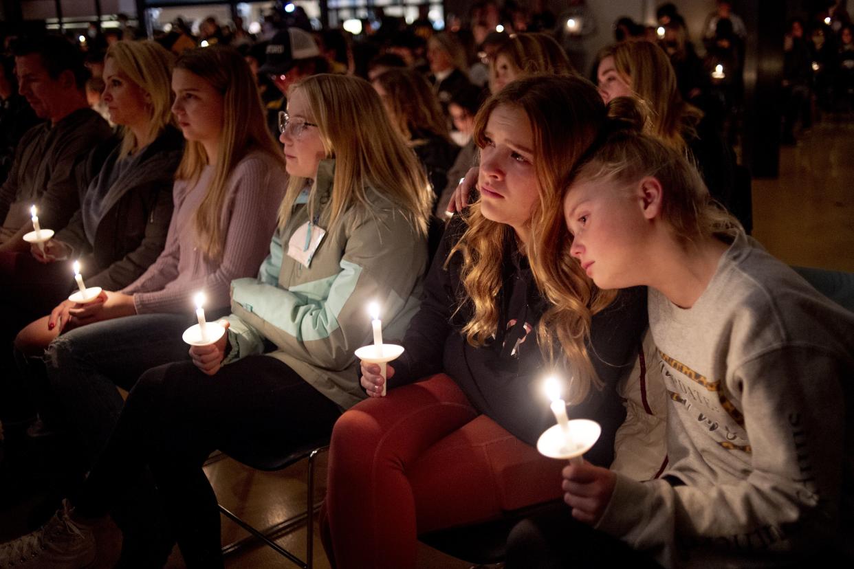 Emerson Miller, right, leans on her friend Joselyn's shoulder as they listen to Jessi Holt, pastor at LakePoint Community Church, during a prayer vigil at the church after the Oxford High School school shooting on Tuesday.