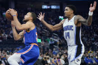 Golden State Warriors guard Stephen Curry, left, shoots against Orlando Magic guard Gary Harris (14) during the first half of an NBA basketball game in San Francisco, Monday, Dec. 6, 2021. (AP Photo/Jeff Chiu)