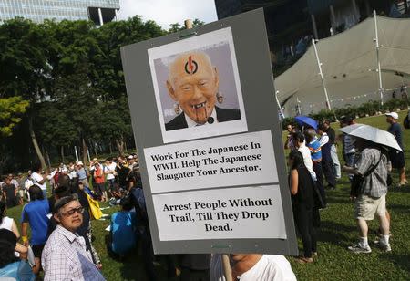 A demonstrator holds up a placard during a protest to free blogger Amos Yee, at Hong Lim Park in Singapore July 5, 2015. REUTERS/Edgar Su