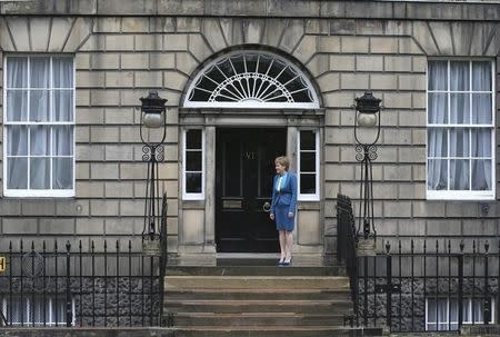 Scotland's First Minister, Nicola Sturgeon, waits to greet Britain's new Prime Minister, Theresa May, at Bute House in Edinburgh, Scotland, Britain July 15, 2016. REUTERS/Russell Cheyne