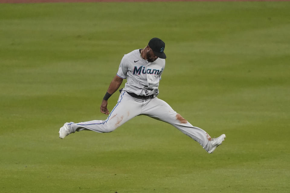 Miami Marlins center fielder Starling Marte leaps after the Marlins defeated the Atlanta Braves 4-2 a baseball game, early Friday, Sept. 25, 2020, in Atlanta. (AP Photo/John Bazemore)