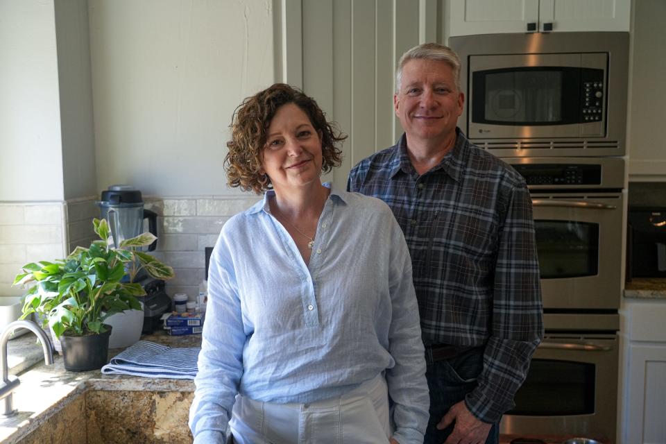 Jill Zinsmeyer poses for a photo with her husband Kurt Zinsmeyer in the kitchen of their Lakeway, Texas home on Friday, April 12, 2024. After moving to Texas, Jill had severe reactions to insect stings and to heat and extreme changes in temperature. Doctors diagnoesd her with indolent systemic mastocytosis, a rare form of systemic mastovytosis.