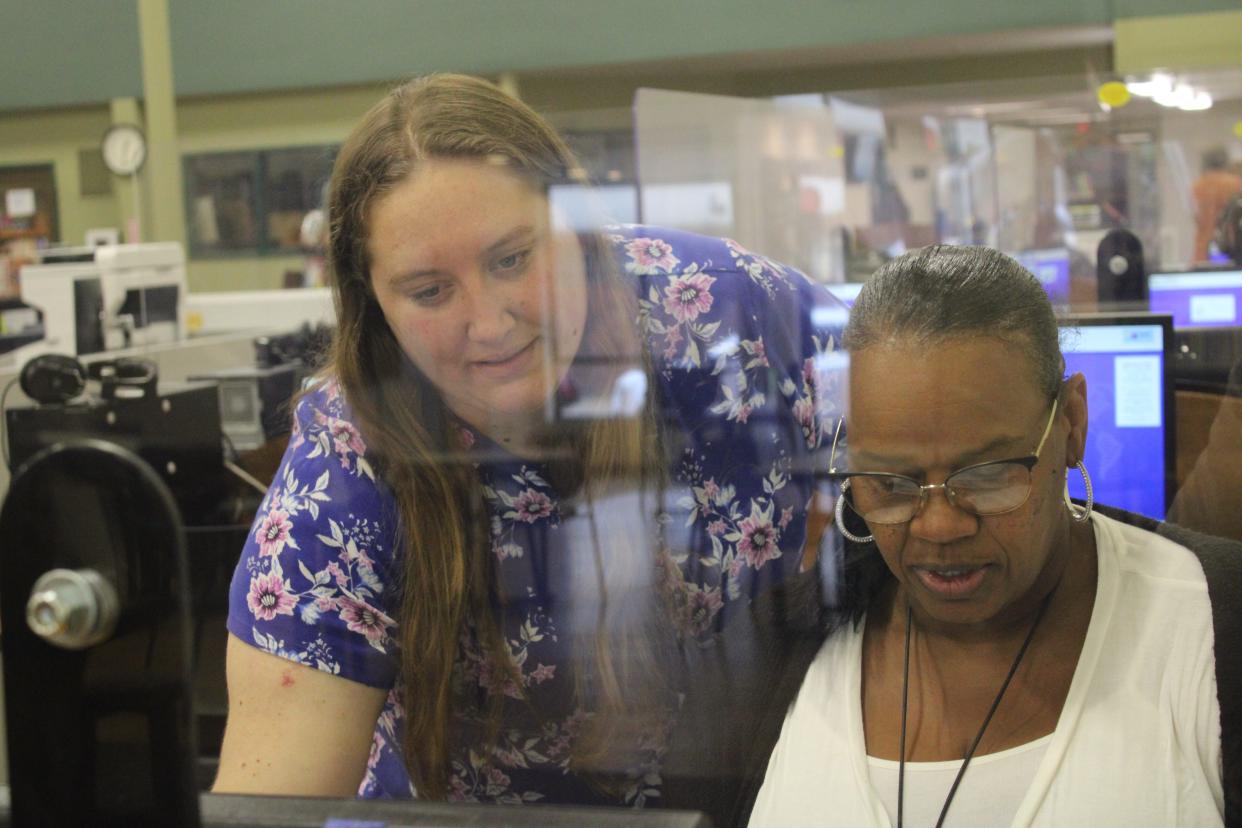 Adrian District Library Assistant Director Chelsey Boss, left, assists a library patron while using one of the library's desktop computers. The library will partner with Michigan Works Southeast next week to offer a Computer Crash Course program from 1:30 to 3:30 p.m. Wednesday, June 1.