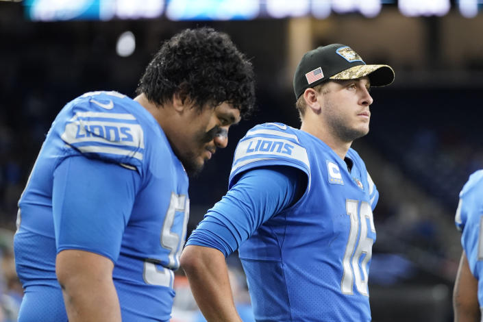 Detroit Lions offensive tackle Penei Sewell, left, and quarterback Jared Goff are sen in the bench area during the second half of an NFL football game against the Philadelphia Eagles, Sunday, Oct. 31, 2021, in Detroit. (AP Photo/Paul Sancya)