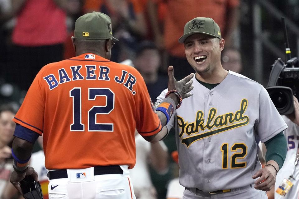 Houston Astros' Dusty Baker Jr., left, greets Oakland Athletics' Aledmys Diaz to present him his 2022 World Series Championship ring before before a baseball game Friday, May 19, 2023, in Houston. (AP Photo/David J. Phillip)