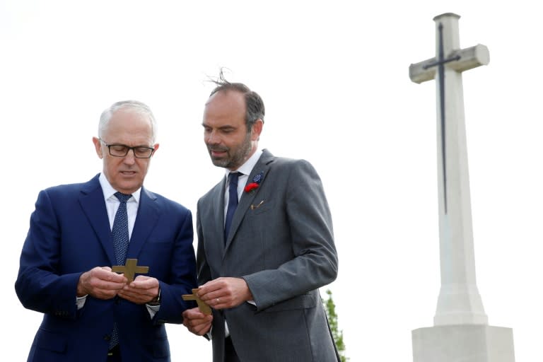 French Prime Minister Edouard Philippe (R) and Australian Prime Minister Malcolm Turnbull speak at the military cemetery in Villers-Bretonneux on the eve of ANZAC Day