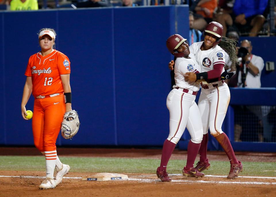 Florida State's Jahni Kerr (4), left, and Florida State.'s Amaya Ross (12) celebrates following a softball game between Oklahoma State Cowgirls and Florida State in the Women's College World Series at USA Softball Hall of Fame Stadium in  in Oklahoma City, Thursday, June, 1, 2023.