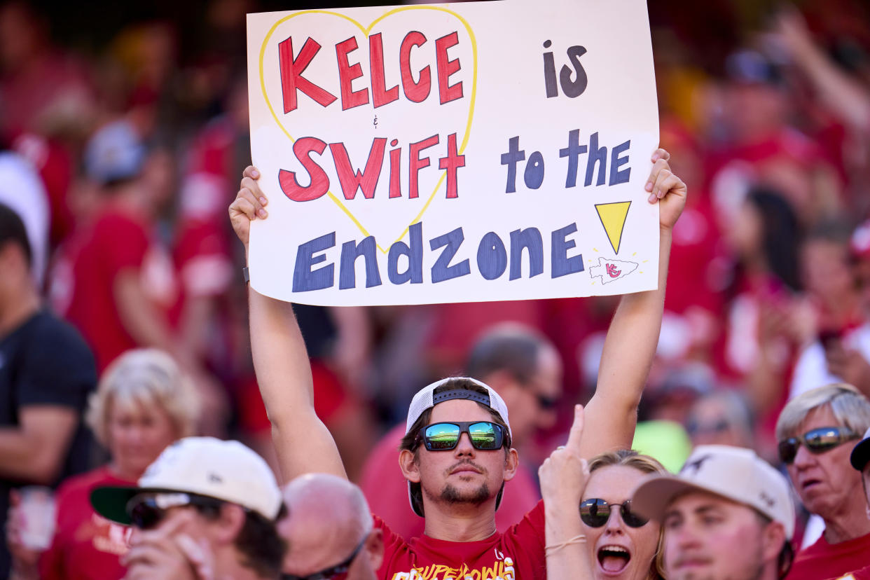 KANSAS CITY, MO - SEPTEMBER 24: A fan holds a sign supporting Taylor Swift and Travis Kelce as the Kansas City Chiefs play the Chicago Bears during the first half at GEHA Field at Arrowhead Stadium on September 24, 2023 in Kansas City, Missouri. (Photo by Cooper Neill/Getty Images)