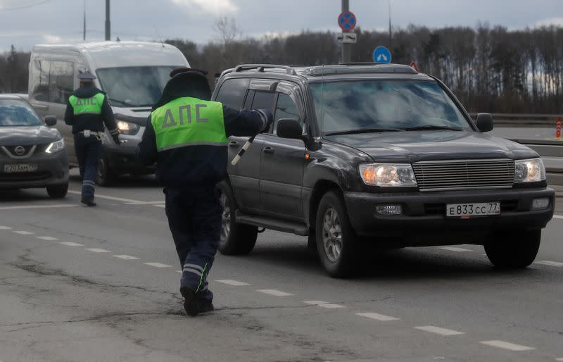 Traffic police officers check cars on the outskirts of Moscow