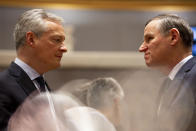 French Finance Minister Bruno Le Maire, left, speaks with Slovenian Finance Minister Andrej Bertoncelj during a meeting of EU finance ministers at the Europa building in Brussels, Tuesday, Feb. 18, 2020. EU finance ministers meet Tuesday to discuss tax havens. (AP Photo/Virginia Mayo)