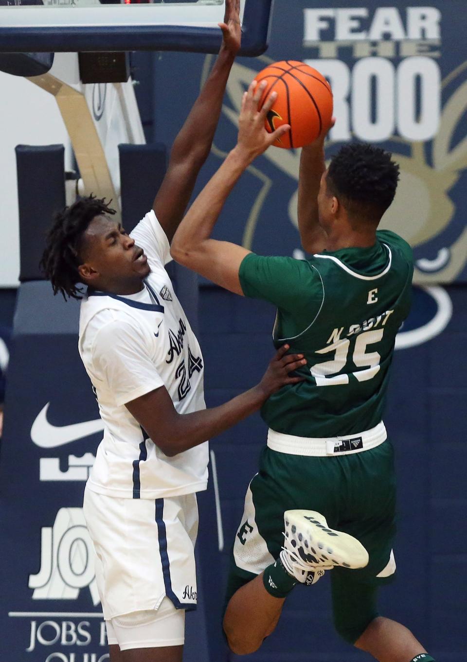 University of Akron forward Ali Ali (24) blocks the shot of Eastern Michigan forward Nate Scott (25) during the Zips' 46-44 victory on Saturday. [Jeff Lange/Beacon Journal]