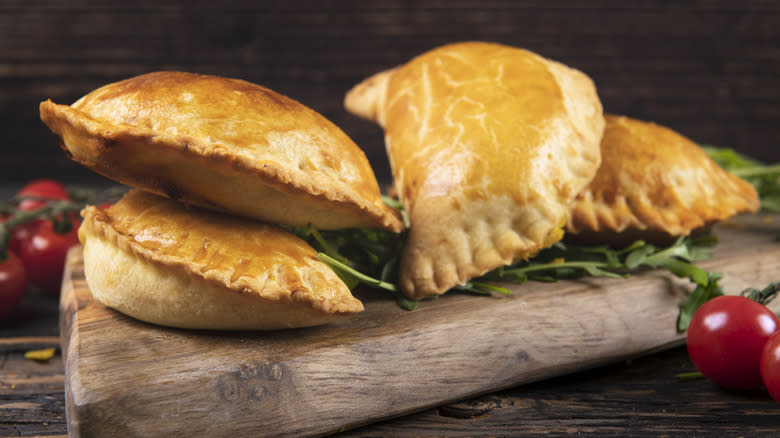 empanadas stacked on board