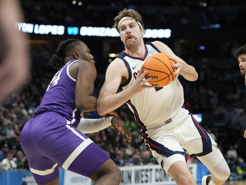 Gonzaga forward Drew Timme, right, drives past Grand Canyon forward Yvan Ouedraogo during the first half of a first-round college basketball game in the men's NCAA Tournament on Friday, March 17, 2023, in Denver. (AP Photo/David Zalubowski)