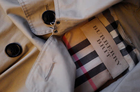 FILE PHOTO: A close up picture shows the label of British fashion design house Burberry inside a Burberry trench coat at a fashion shop in Frankfurt, Germany, March 15, 2016. REUTERS/Kai Pfaffenbach/File Photo