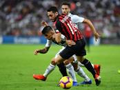 Soccer Football - Italian Super Cup - Juventus v AC Milan - King Abdullah Sports City, Jeddah, Saudi Arabia - January 16, 2019 Juventus' Joao Cancelo in action with AC Milan's Hakan Calhanoglu REUTERS/Waleed Ali