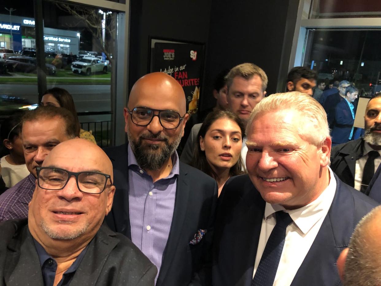 Premier Doug Ford and PC MPP-elect Zee Hamid (centre) at the PC victory party in Milton. Hamid won the Milton byelection with about 47% of the vote.  (Clara Pasieka/CBC - image credit)