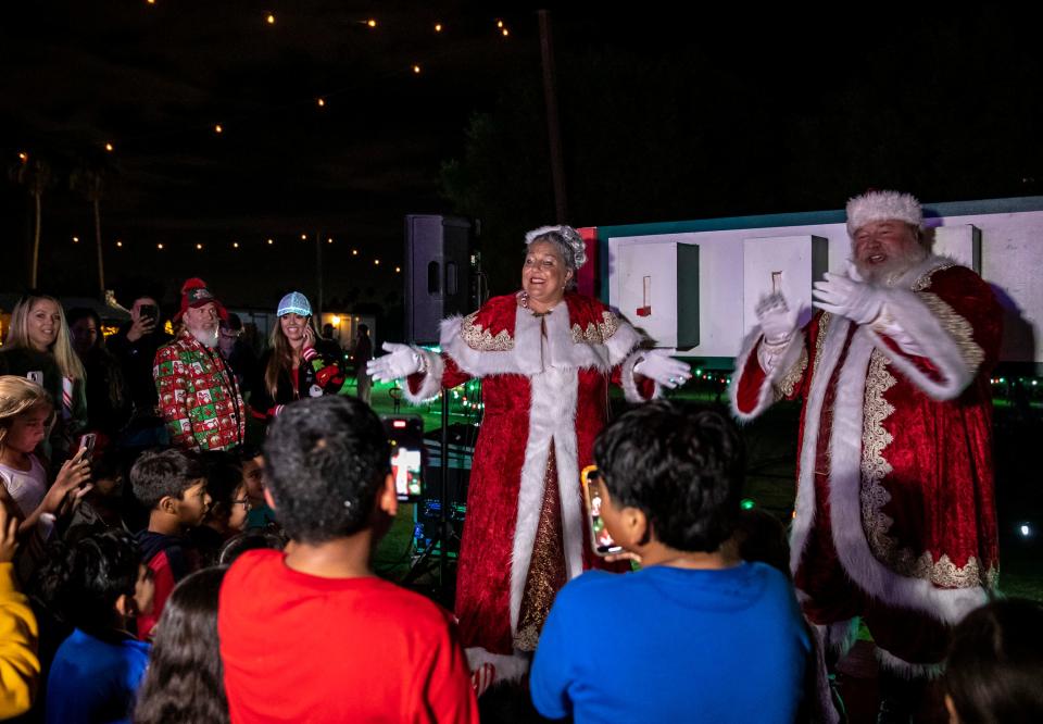 Mrs. Claus and Santa lead kids in holiday-themed songs during the opening ceremony of the Magic of Lights holiday display at the Empire Polo Club in Indio, Calif., Thursday, Nov. 16, 2023.