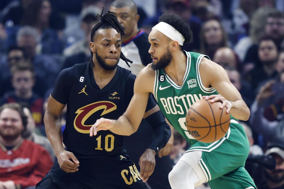 Boston Celtics guard Derrick White (9) drives against Cleveland Cavaliers guard Darius Garland (10) during the first half of an NBA basketball game, Monday, March 6, 2023, in Cleveland. (AP Photo/Ron Schwane)