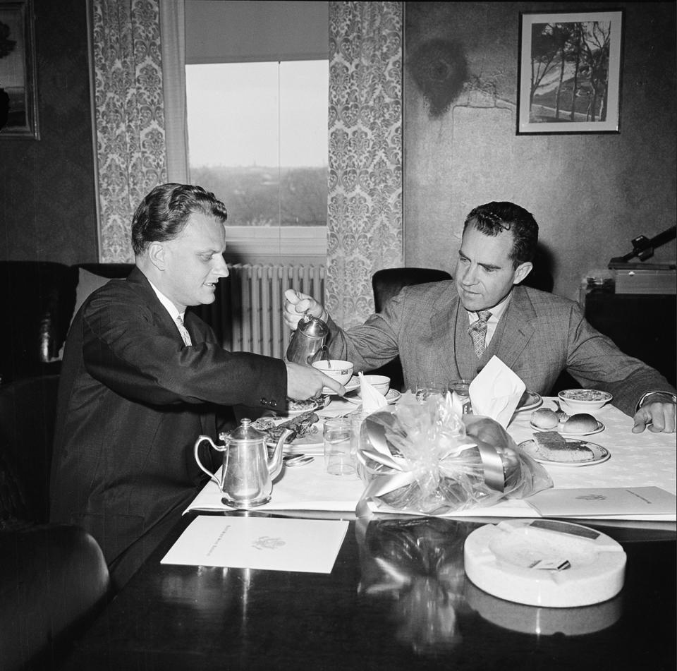 <p>Vice President Richard Nixon pours coffee for Billy Graham in Nixon’s private office in Washington, D.C., on March 31, 1960. (Photo: AP) </p>