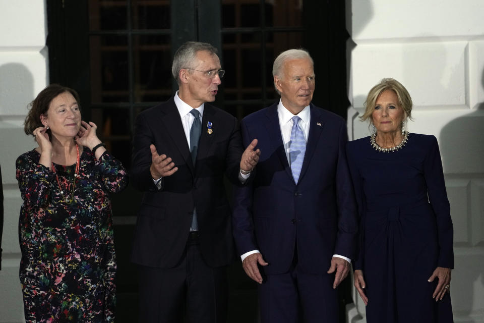 President Joe Biden and first lady Jill Biden talks with NATO Secretary General Jens Stoltenberg and his wife Ingrid Schulerud as they welcome NATO allies and partners to the White House in Washington, Wednesday, July 10, 2024, on the South Lawn for the 75th anniversary of the NATO Summit. (AP Photo/Susan Walsh)