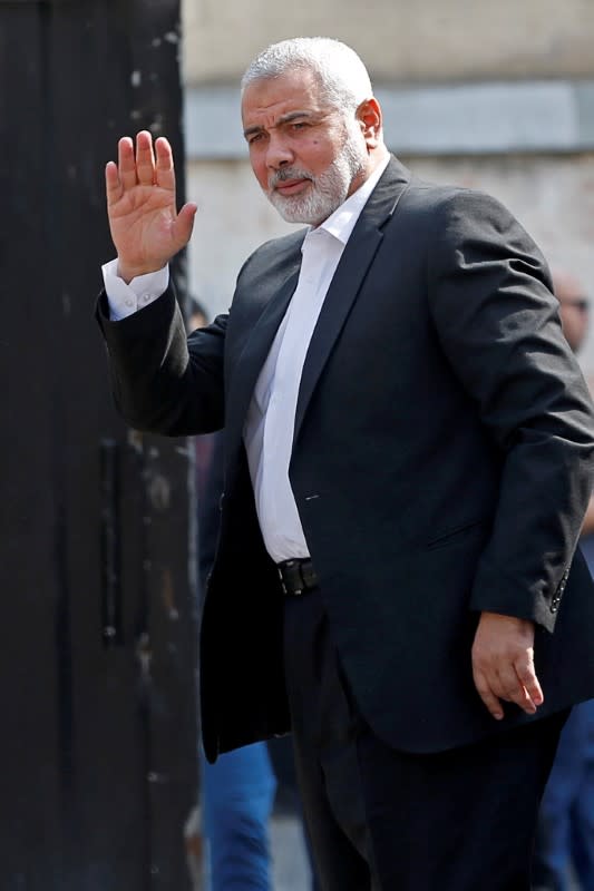 FILE PHOTO: Palestinian Hamas Chief Haniyeh waves before meeting with Chairman of the Palestinian Central Election Committee Naser in Gaza