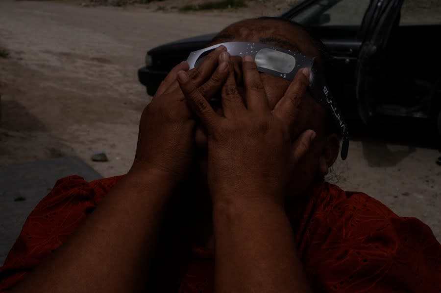 22 DE FEBRERO, MEXICO – APRIL 8: A woman watches the eclipse using special glasses on April 8, 2024 in 22 de Febrero, Mexico. Millions of people have flocked to areas across North America that are in the path of totality in order to experience a total solar eclipse. During the event, the moon will pass in between the sun and the Earth, appearing to block the sun. (Photo by Cristopher Rogel Blanquet/Getty Images)