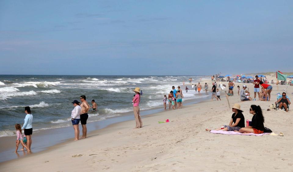 People are seen at Field 3 at Robert Moses State Park in West Islip, N.Y., Tuesday, July 4, 2023. Two swimmers were apparently attacked by sharks off the shores of Long Island on Tuesday, a day after two others reported being attacked while enjoying the water at popular New York beaches.