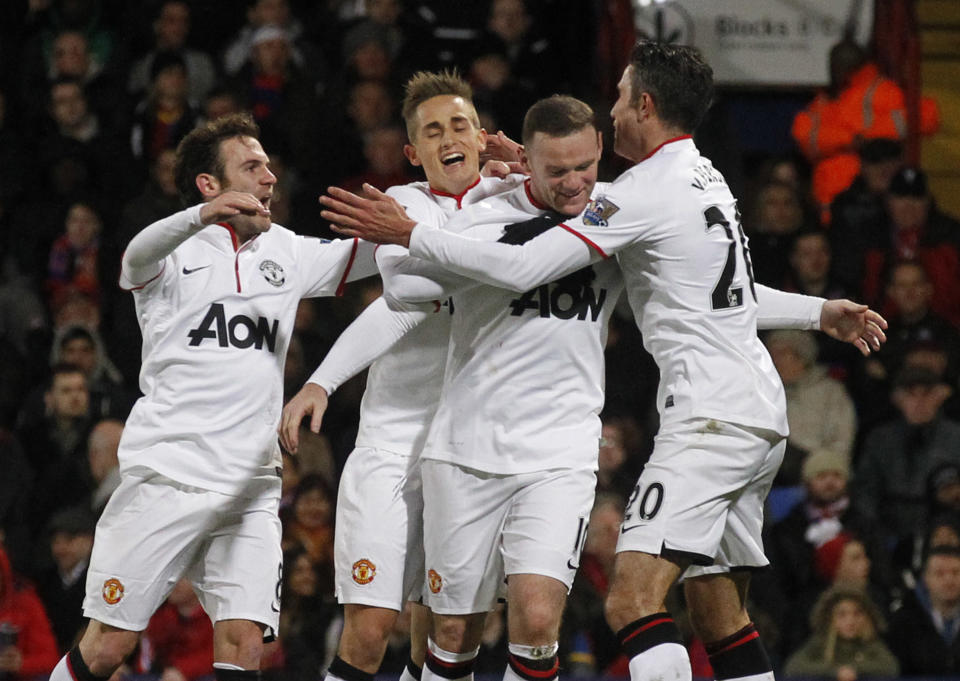 Manchester United's Wayne Rooney, second right, celebrates his goal against Crystal Palace with teammates during their English Premier League soccer match at Selhurst Park, London, Saturday, Feb. 22, 2014. (AP Photo/Sang Tan)