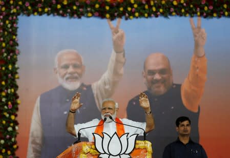 India's Prime Minister Narendra Modi gestures as he addresses his supporters during a public meeting in Ahmedabad