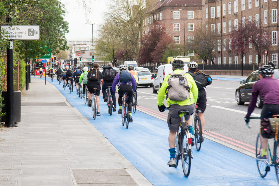 London, England - April 14, 2016: Cyclists using the newly opened segregated Cycle Superhighway at Kennington Oval in South London.