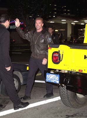 Arnold Schwarzenegger hops out of the Arnoldmobile and prepares to put fiendish arch-villains into traction at the Mann's National Theater premiere of Columbia's The 6th Day