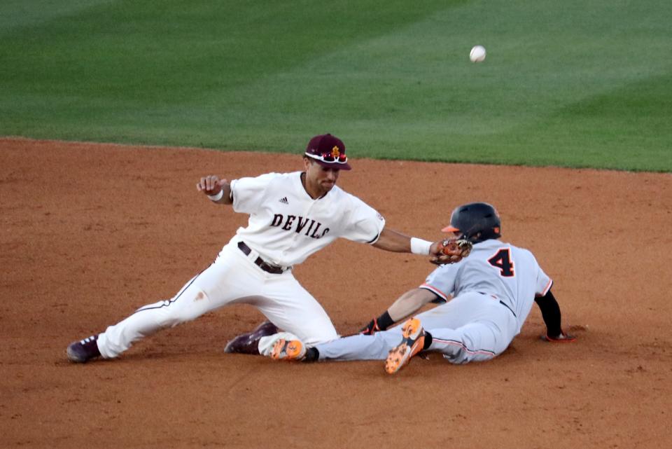 Arizona State shortstop Cam Magee tries to make a tag on Oklahoma State outfielder Zach Ehrhard at second base, but the ball slips away on March 1 in Phoenix.