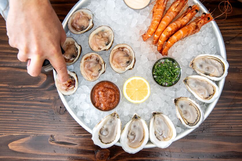 LOS ANGELES, CA- January 21, 2020: Chef Ari Kolender works prepares a tray of oysters, clams and prawns at Found Oyster on Tuesday, January 21, 2020. (Mariah Tauger / Los Angeles Times)